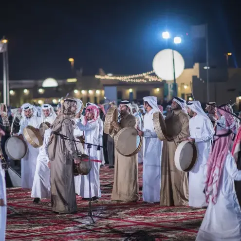 Cultural installations, night lights, visitor crowds, stage