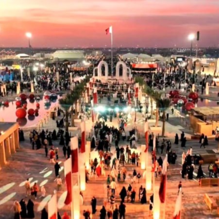 Cultural installations, night lights, visitor crowds, stage