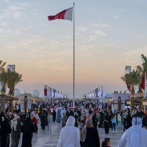 Cultural installations, night lights, visitor crowds, stage