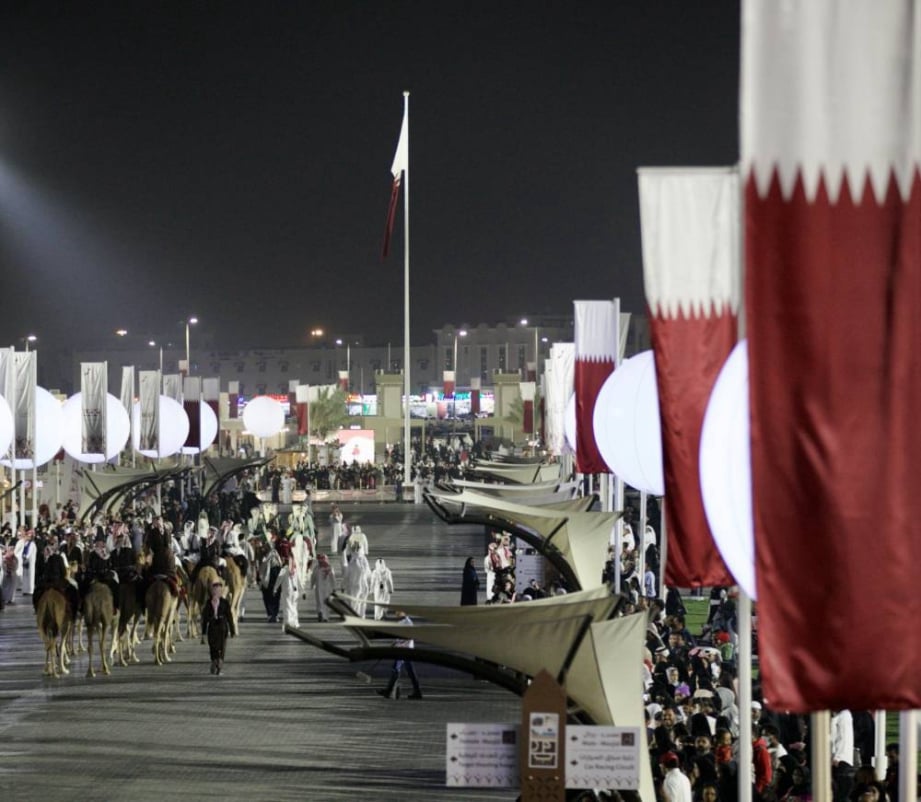 Cultural installations, night lights, visitor crowds, stage