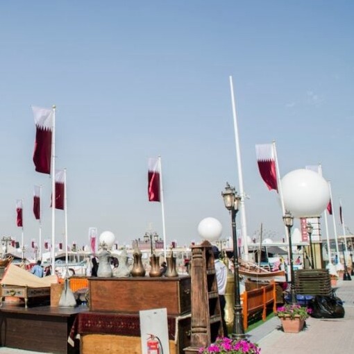 Cultural installations, night lights, visitor crowds, stage