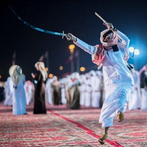 Cultural installations, night lights, visitor crowds, stage